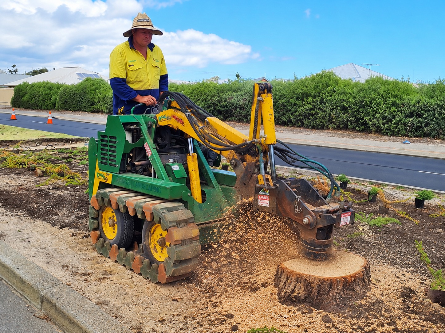 Country Landscaping & Irrigation grinding out a tree stump with a stump grinder on a South West WA verge